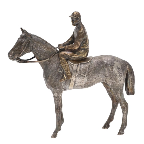 234 - A MODERN CAST SILVER FIGURE OF A RACEHORSE & JOCKEY. the jockey seated & holding reins, by SMD Casti... 