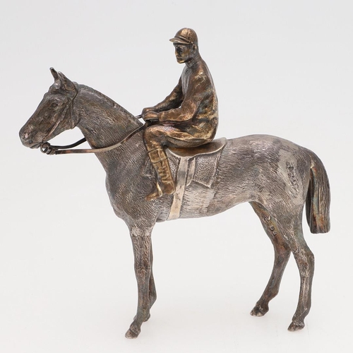 234 - A MODERN CAST SILVER FIGURE OF A RACEHORSE & JOCKEY. the jockey seated & holding reins, by SMD Casti... 