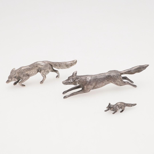 235 - A MODERN SILVER FIGURE OF A RUNNING FOX. makers mark partially lost in decoration, London 1963, toge... 