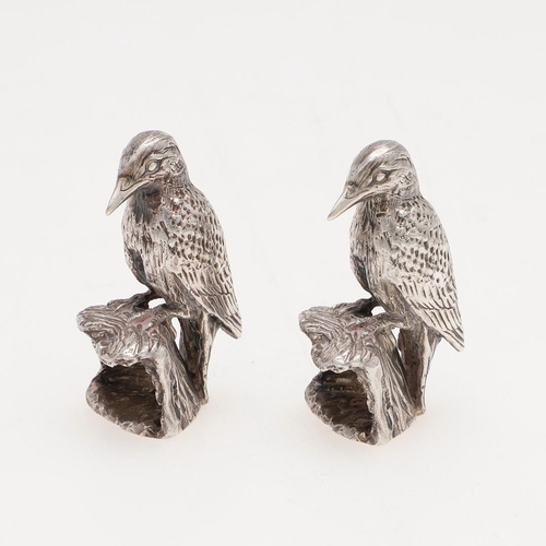 239 - A PAIR OF MODERN SILVER FIGURES OF WOODPECKERS. perched on tree stumps, by Paul Eaton, London 1990; ... 