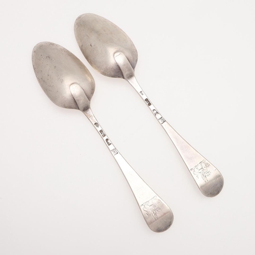 25 - A PAIR OF GEORGE III HANOVERIAN PATTERN SILVER TABLE SPOONS. crested on the back of their terminals,... 