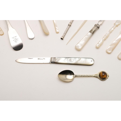 254 - A MIXED LOT. including 7 mother-of-pearl implements, a pickle fork & condiment spoon with mother-of-... 