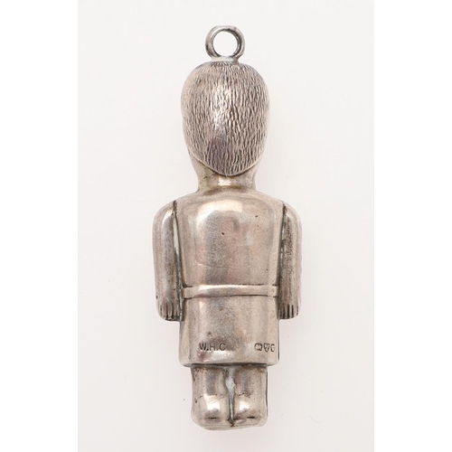 258 - A 20TH CENTURY SILVER CHILD'S RATTLE. in the form of a guardsman and with a suspensory ring, by W.H ... 