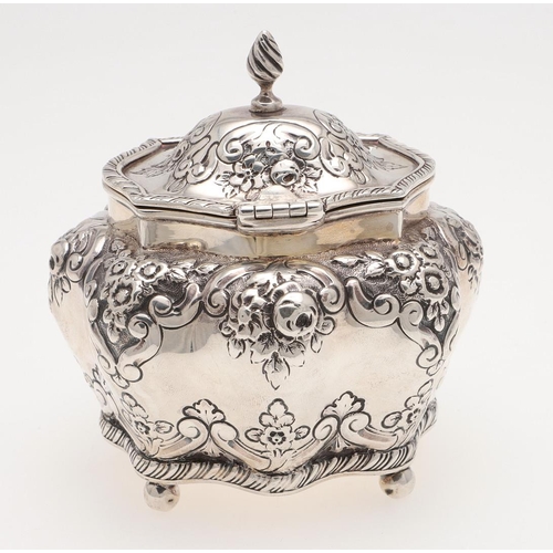 259 - A LATE VICTORIAN EMBOSSED SILVER TEA CADDY. bombÃé form, with a wrythen finial, ball feet & a gilt i... 