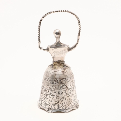 273 - A SILVER BELL. in the form of a lady wearing a crinoline dress with a rope in her hands, the chased ... 