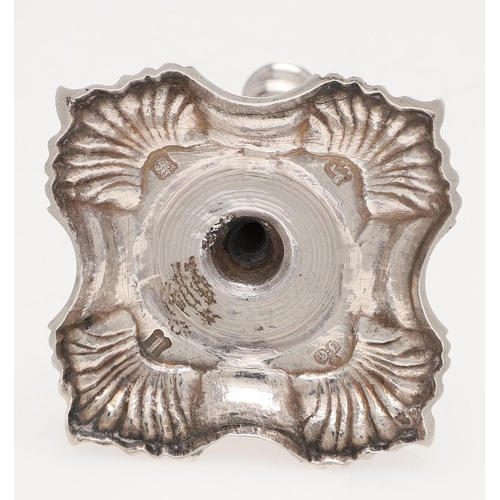 274 - A GEORGE II CAST SILVER TAPERSTICK. on a shaped square base, with shell decoration, a knopped stem a... 