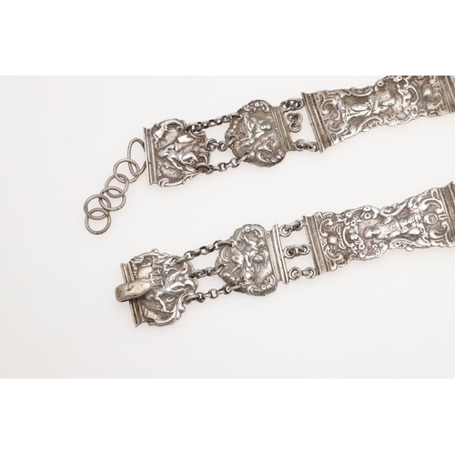 296 - A DUTCH SILVER BELT. with alternating panels decorated in relief with figures within scroll borders,... 