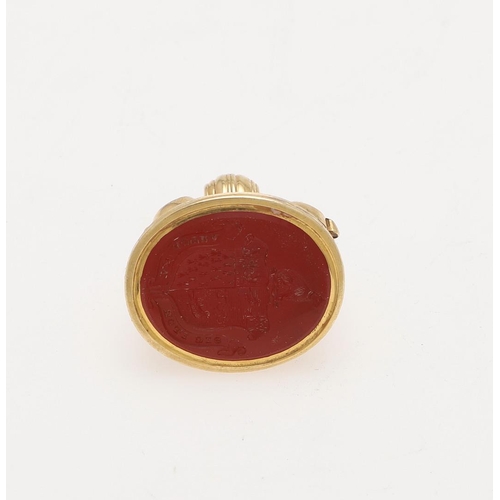 314 - A 19TH CENTURY GOLD FOB SEAL. with scrolling decoration, a reeded border and a carnelian matrix engr... 