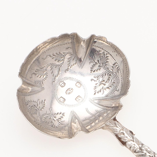 42 - A WILLIAM IV SILVER CADDY SPOON. with an embossed stem & terminal, initialled on the reverse &  the ... 