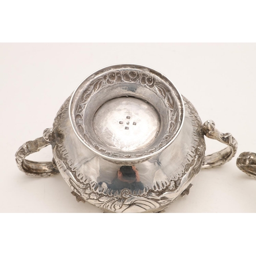 79 - A WILLIAM IV IRISH SILVER THREE-PIECE TEA SET. of circular form, with leaf-capped scroll handles, em... 