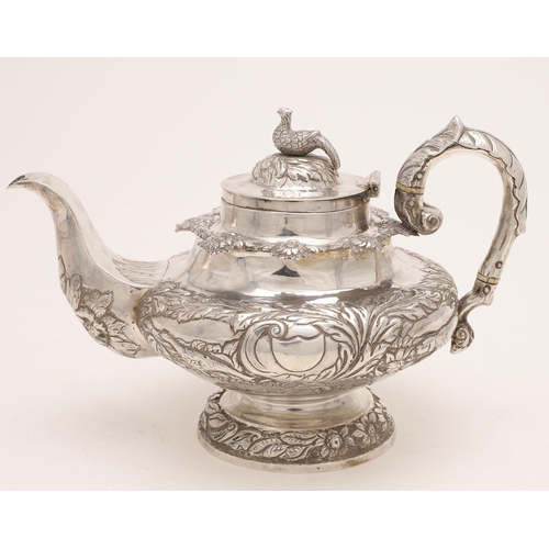 79 - A WILLIAM IV IRISH SILVER THREE-PIECE TEA SET. of circular form, with leaf-capped scroll handles, em... 