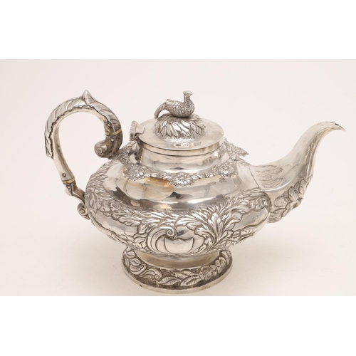 79 - A WILLIAM IV IRISH SILVER THREE-PIECE TEA SET. of circular form, with leaf-capped scroll handles, em... 