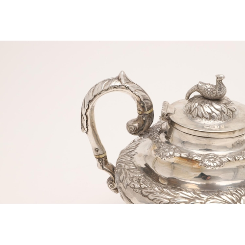 79 - A WILLIAM IV IRISH SILVER THREE-PIECE TEA SET. of circular form, with leaf-capped scroll handles, em... 