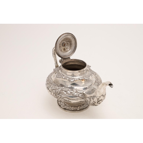 79 - A WILLIAM IV IRISH SILVER THREE-PIECE TEA SET. of circular form, with leaf-capped scroll handles, em... 