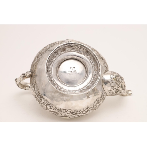 79 - A WILLIAM IV IRISH SILVER THREE-PIECE TEA SET. of circular form, with leaf-capped scroll handles, em... 