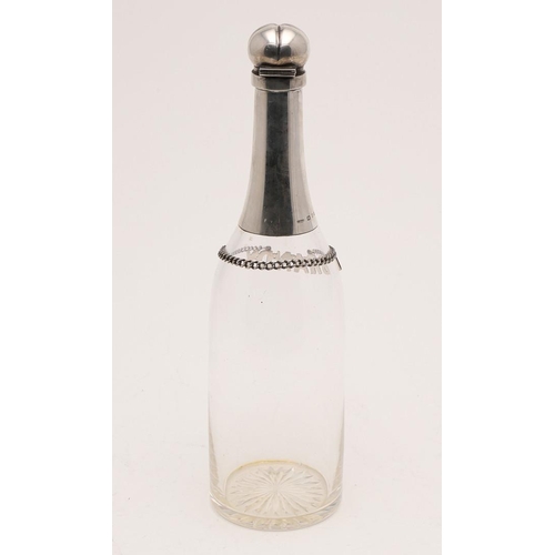 80 - A LATE VICTORIAN SILVER MOUNTED CLEAR GLASS BOTTLE. with a star-cut base and a hinged cover, togethe... 