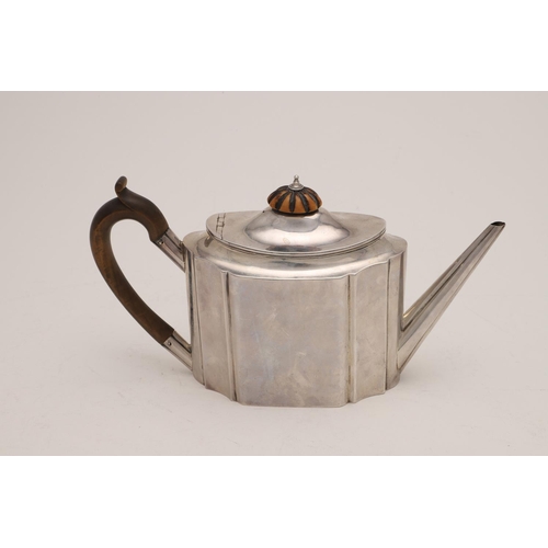 82 - A GEORGE III SILVER TEAPOT. of shaped oval outline, with a wooden 'C'-scroll handle and an ivory fin... 