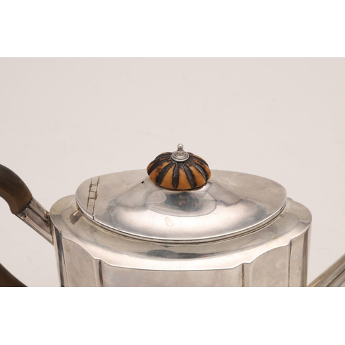 82 - A GEORGE III SILVER TEAPOT. of shaped oval outline, with a wooden 'C'-scroll handle and an ivory fin... 