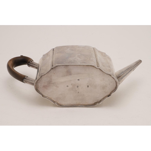 82 - A GEORGE III SILVER TEAPOT. of shaped oval outline, with a wooden 'C'-scroll handle and an ivory fin... 