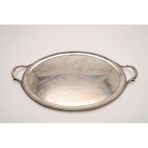 83 - A VICTORIAN TWO-HANDLED SILVER TEA TRAY. with gadrooned borders, twin leaf-capped handles, engraved ... 