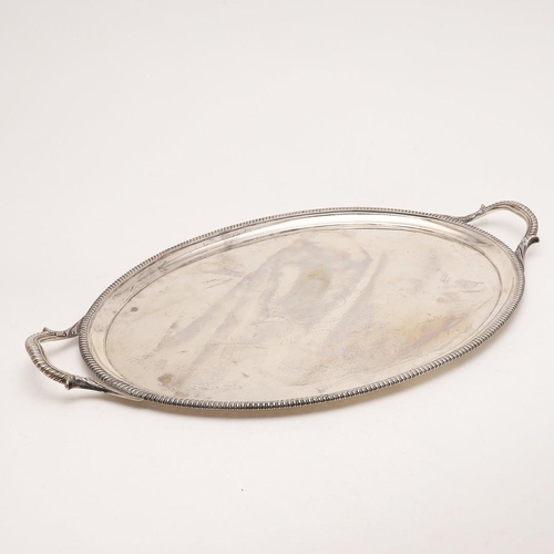 83 - A VICTORIAN TWO-HANDLED SILVER TEA TRAY. with gadrooned borders, twin leaf-capped handles, engraved ... 