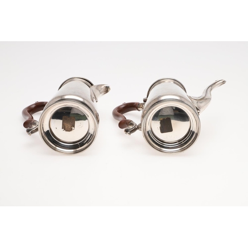 93 - A PAIR OF GEORGE V TAPERING SILVER CAFE AU LAIT POTS. with domed covers, knop finials and scroll han... 