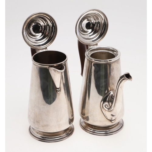 93 - A PAIR OF GEORGE V TAPERING SILVER CAFE AU LAIT POTS. with domed covers, knop finials and scroll han... 