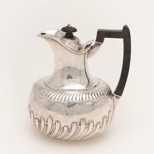 94 - A VICTORIAN SILVER HOT WATER JUG. oval outline, with a bellied body and part-fluted decoration, by M... 