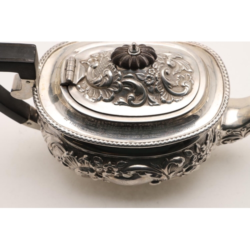 96 - A LATE VICTORIAN EMBOSSED SILVER TEA POT. rounded oblong, with a gadrooned border and inscribed 