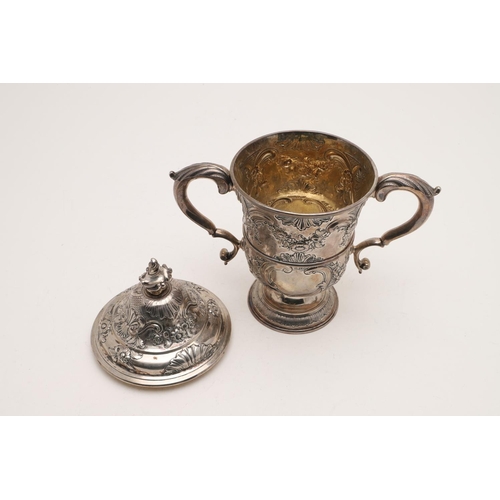 99 - A GEORGE III NORTH-COUNTRY PROVINCIAL TWO-HANDLED SILVER CUP. of campana form, with later embossing ... 