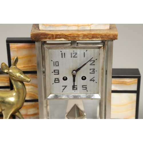 1148 - AN ART DECO MARBLE AND ONYX CLOCK GARNITURE. of architectural form, the two train clock striking the... 