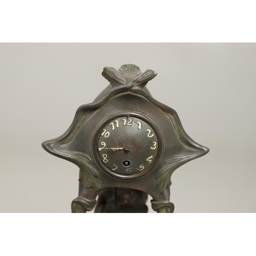 1150 - A CONTINENTAL ART NOUVEAU SPELTER CLOCK. the central stem modelled with a maiden, within a stylised ... 