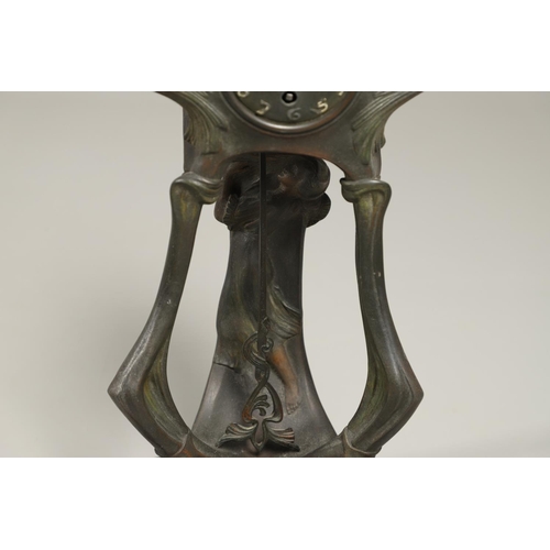 1150 - A CONTINENTAL ART NOUVEAU SPELTER CLOCK. the central stem modelled with a maiden, within a stylised ... 