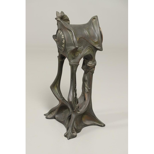 1150 - A CONTINENTAL ART NOUVEAU SPELTER CLOCK. the central stem modelled with a maiden, within a stylised ... 