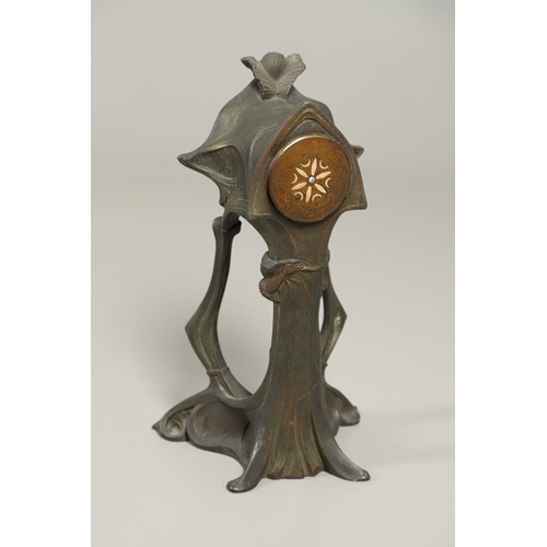 1150 - A CONTINENTAL ART NOUVEAU SPELTER CLOCK. the central stem modelled with a maiden, within a stylised ... 