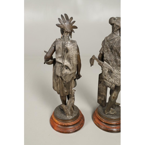 1173 - A PAIR OF BRONZED METAL WEST INDIAN/CARIBBEAN FIGURES. 20th century, each in tribal attire with feat... 