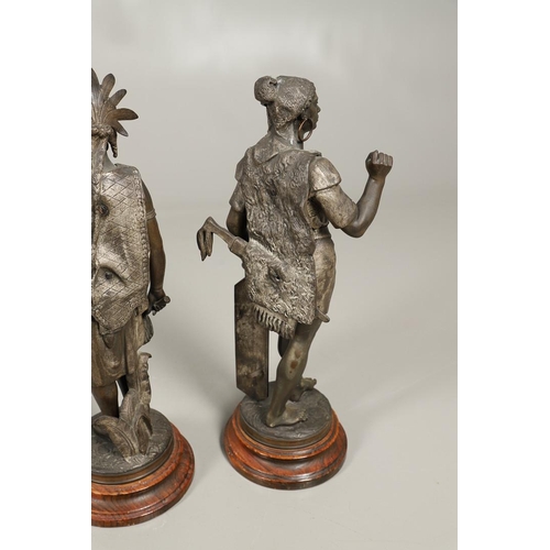 1173 - A PAIR OF BRONZED METAL WEST INDIAN/CARIBBEAN FIGURES. 20th century, each in tribal attire with feat... 