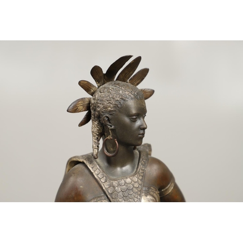 1173 - A PAIR OF BRONZED METAL WEST INDIAN/CARIBBEAN FIGURES. 20th century, each in tribal attire with feat... 