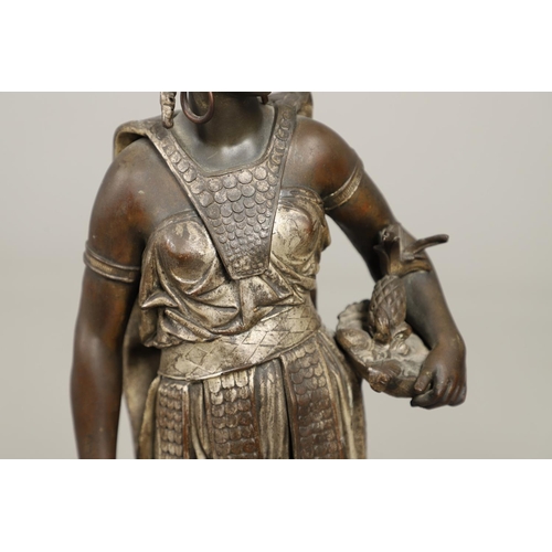 1173 - A PAIR OF BRONZED METAL WEST INDIAN/CARIBBEAN FIGURES. 20th century, each in tribal attire with feat... 