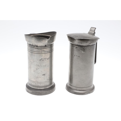 1174 - TWO MID-LATE 19TH CENTURY FRENCH PEWTER LIDDED MEASURES. of double and single litre size, the talles... 