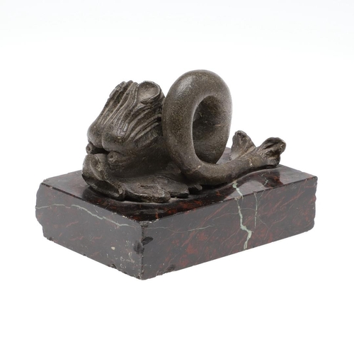 1192 - A 16TH CENTURY STYLE SERPENTINE MARBLE DESK WEIGHT. modelled as a mythical dolphin upon a mottled de... 