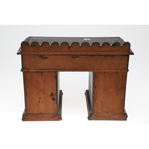 1194 - A PAINTED MINIATURE KNEEHOLE DESK. with carved gallery and an arrangement of nine drawers, height 35... 