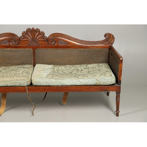 1207 - A REGENCY MAHOGANY CAMPAIGN SOFA. with carved scrolling crest rail and central multiple scroll 'fan'... 