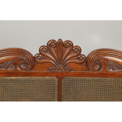 1207 - A REGENCY MAHOGANY CAMPAIGN SOFA. with carved scrolling crest rail and central multiple scroll 'fan'... 