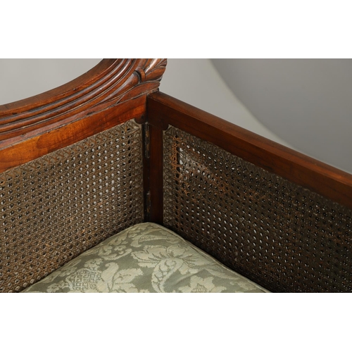 1207 - A REGENCY MAHOGANY CAMPAIGN SOFA. with carved scrolling crest rail and central multiple scroll 'fan'... 