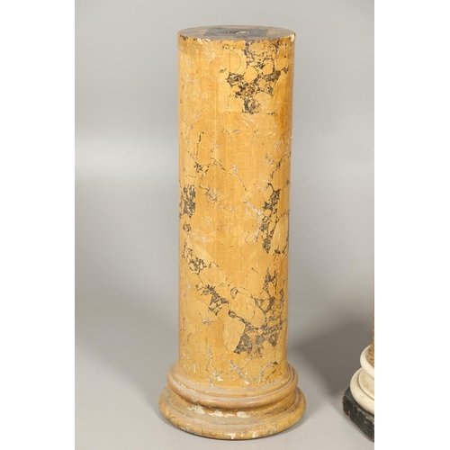 1209 - A PAIR OF YELLOW MARBLE SCAGLIOLA COLUMNS. the taller upon a turned white painted and octagonal ebon... 