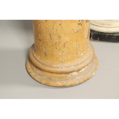 1209 - A PAIR OF YELLOW MARBLE SCAGLIOLA COLUMNS. the taller upon a turned white painted and octagonal ebon... 