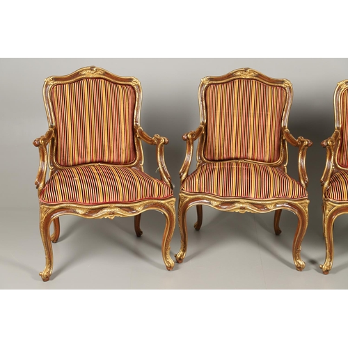 1212 - A SET OF SIX ITALIAN WALNUT AND PARCEL GILT OPEN ARMCHAIRS. by the contemporary designer and craftsm... 