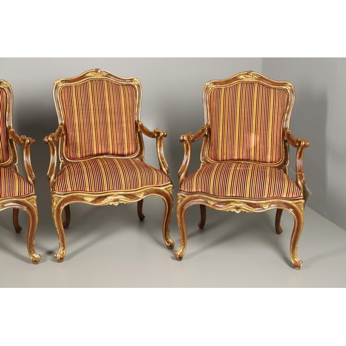 1212 - A SET OF SIX ITALIAN WALNUT AND PARCEL GILT OPEN ARMCHAIRS. by the contemporary designer and craftsm... 