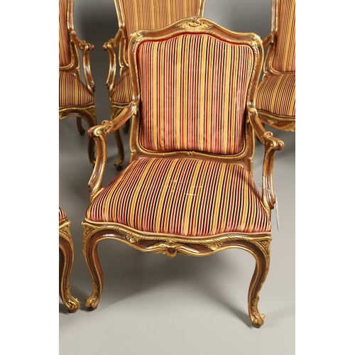 1212 - A SET OF SIX ITALIAN WALNUT AND PARCEL GILT OPEN ARMCHAIRS. by the contemporary designer and craftsm... 